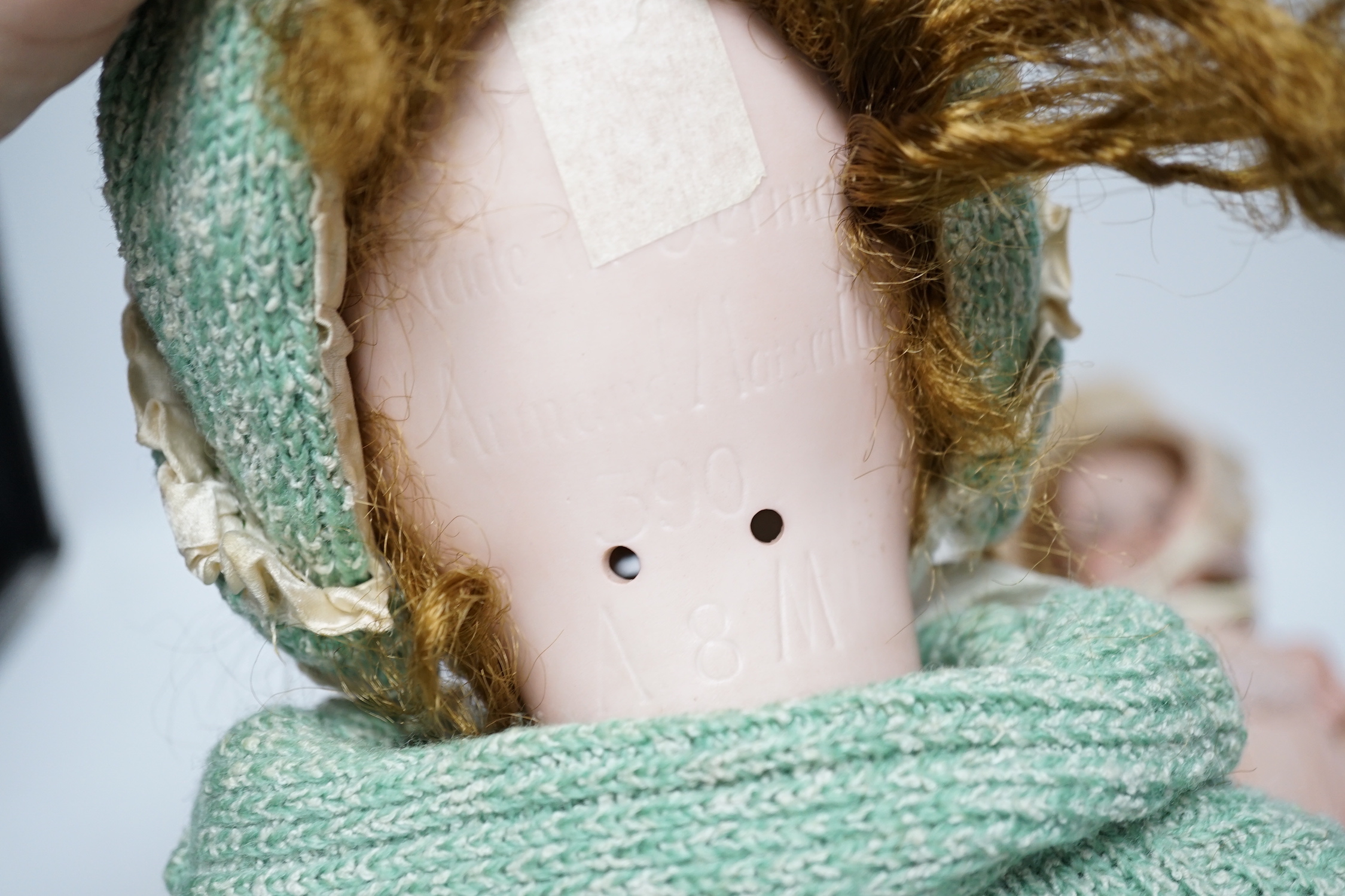 An AM390 bisque head doll, 63cm good condition, and an AM390, missing two fingers and wear on other hand, 58cm